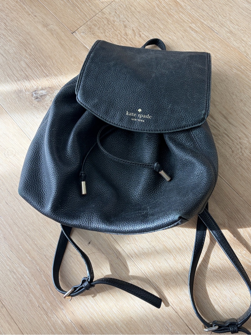 kate spade Black Pebbled Leather Drawstring Flap Backpack